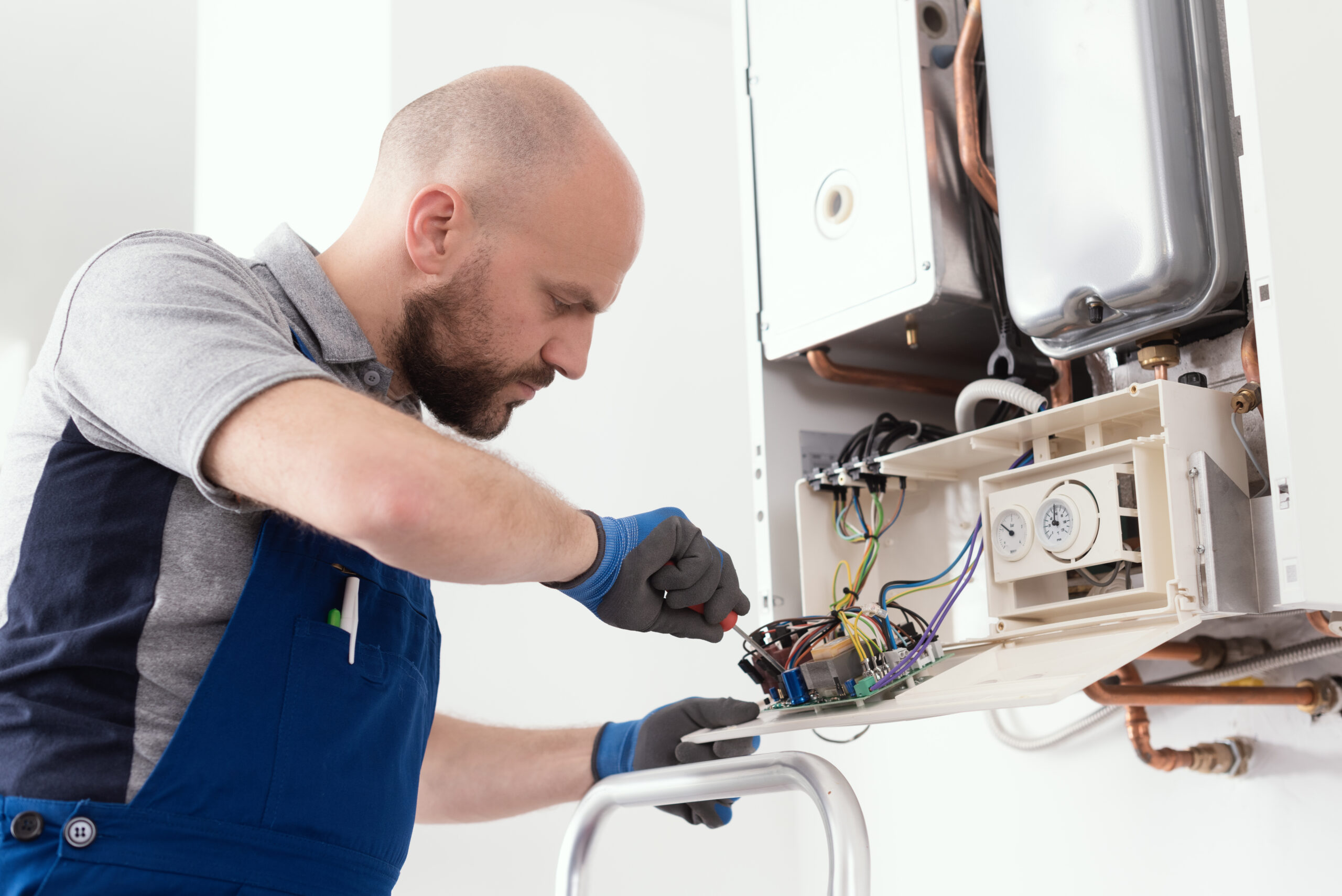 HVAC technician performing a repair service on the home's heating system