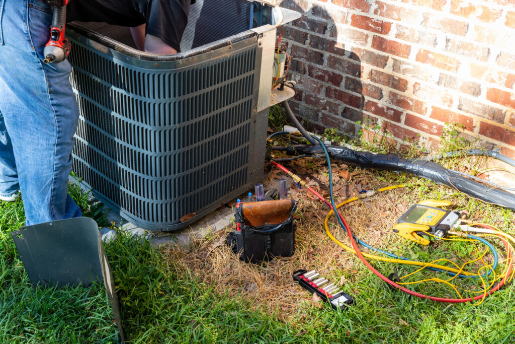 HVAC technician performing a service on a residential HVAC system