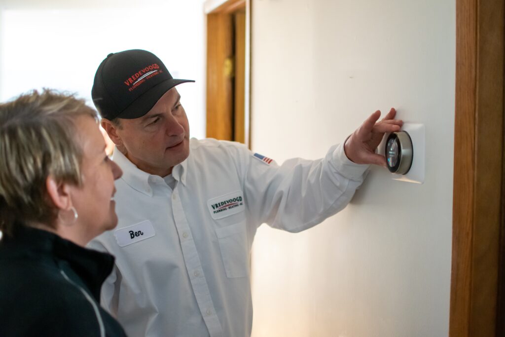 Vredevoogd technician speaking to a Spring Lake homeowner about home services