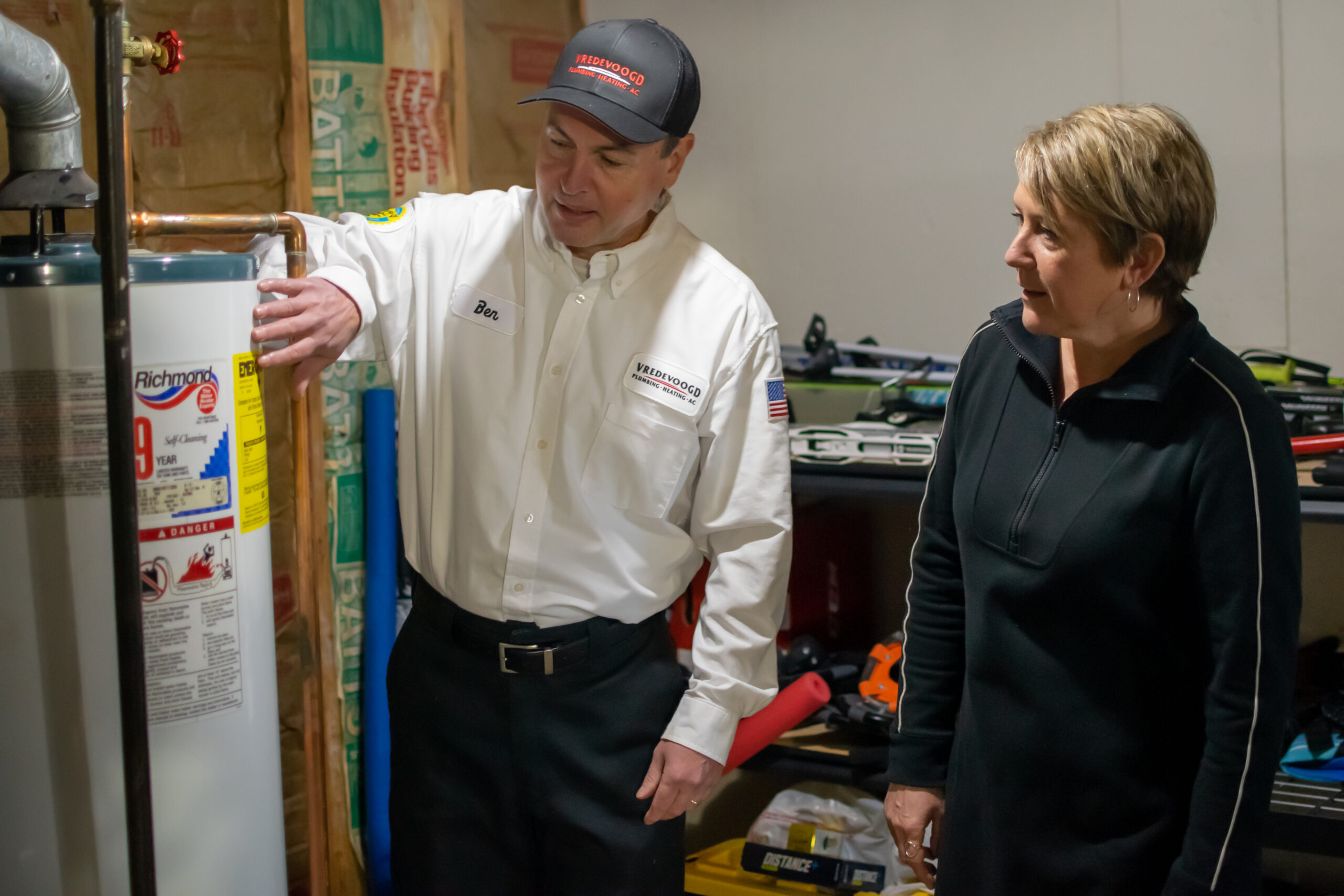 Vredevoogd discussing water heaters with Michigan homeowner