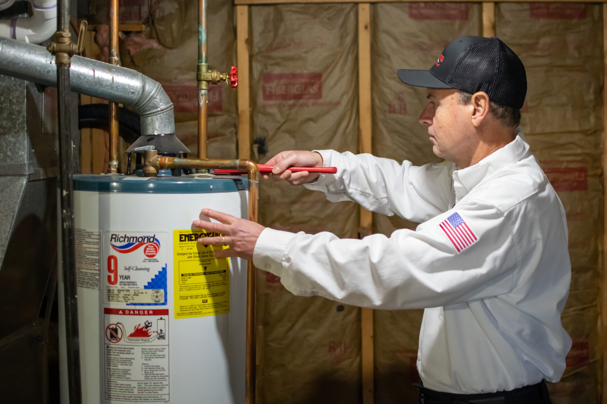 Vredevoogd technician repairing a water heater in a Michigan home