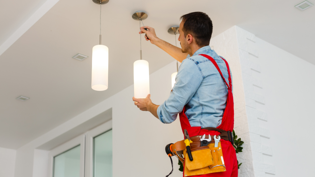 Electrician installing fixtures in West Michigan