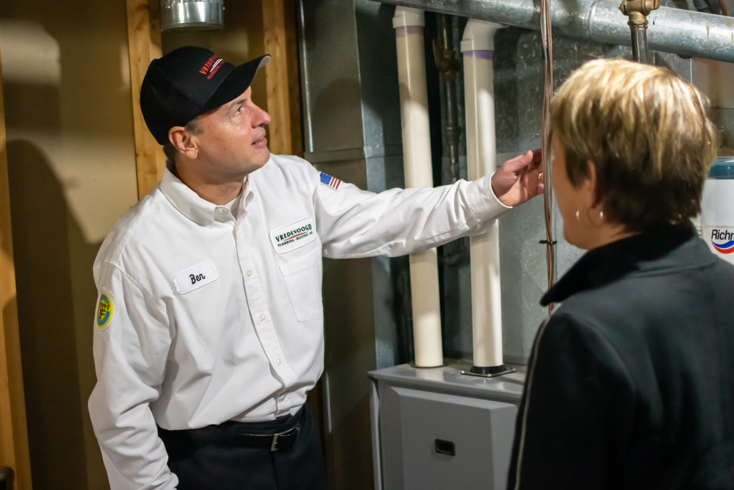 Vredevoogd technician speaking with homeowner about their home's furnace